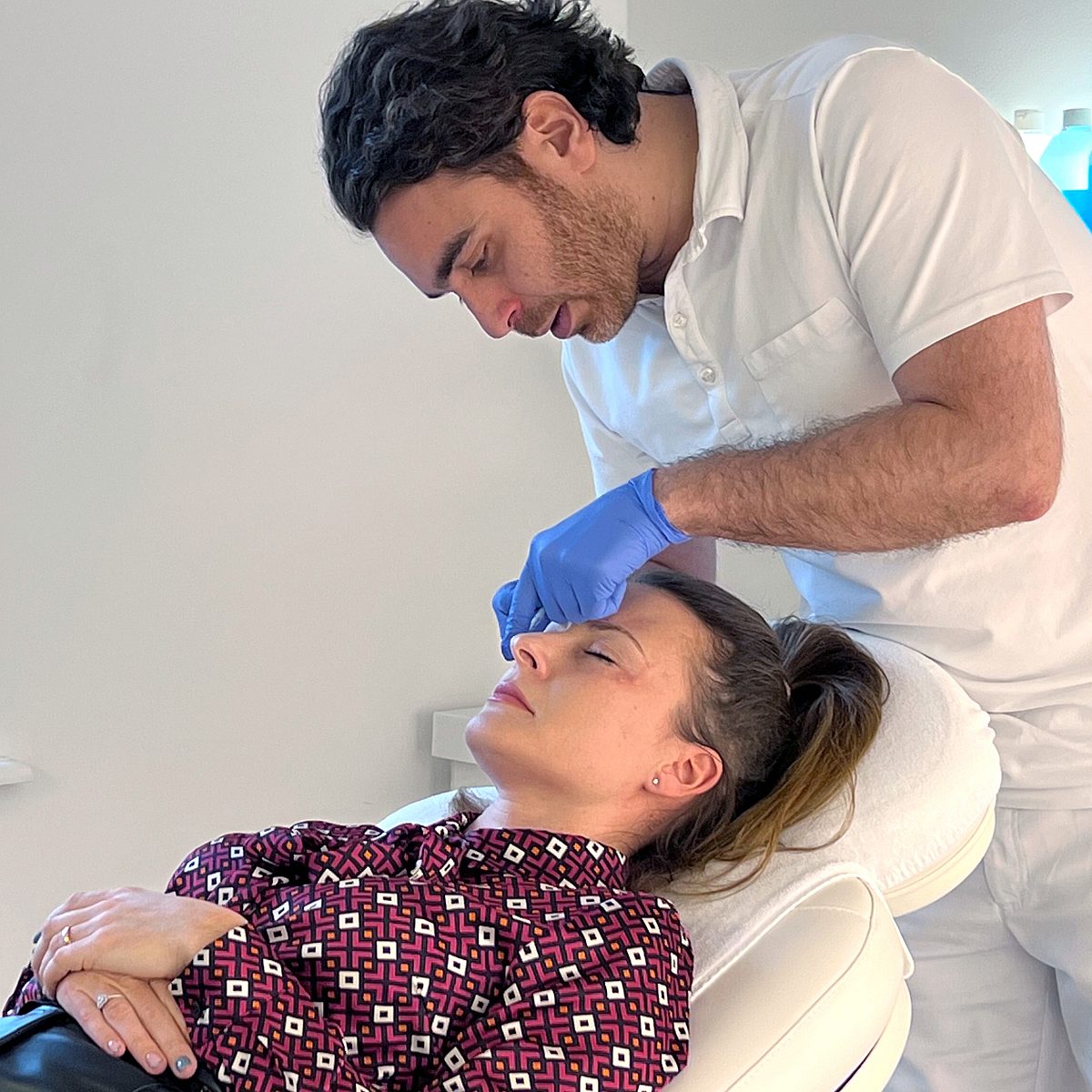 Photo of Ekaterina on the treatment couch during botulinum toxin treatment at Smoothline